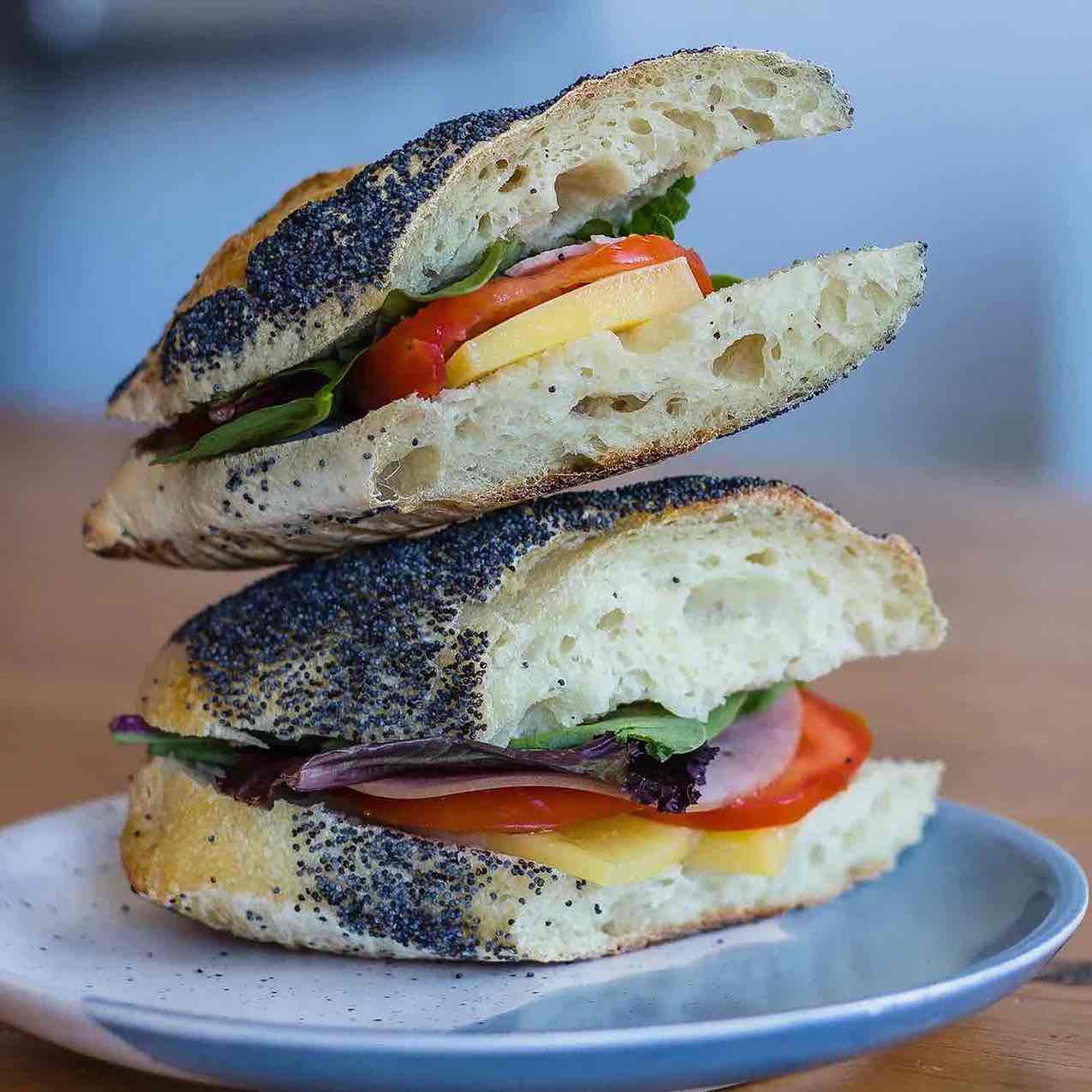 poppy seed baguette sandwich with cheese and tomato