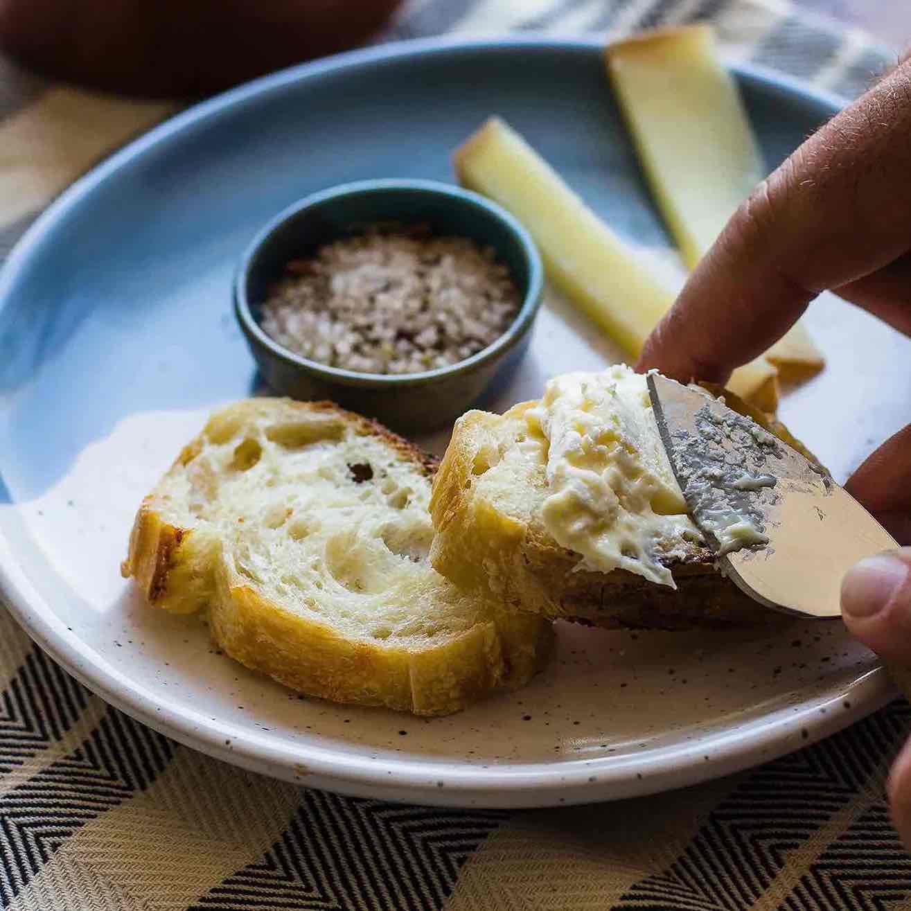 spread butter on baguette